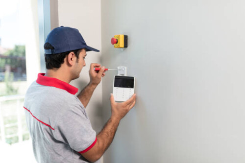 Technician set up keypad of security alarm system